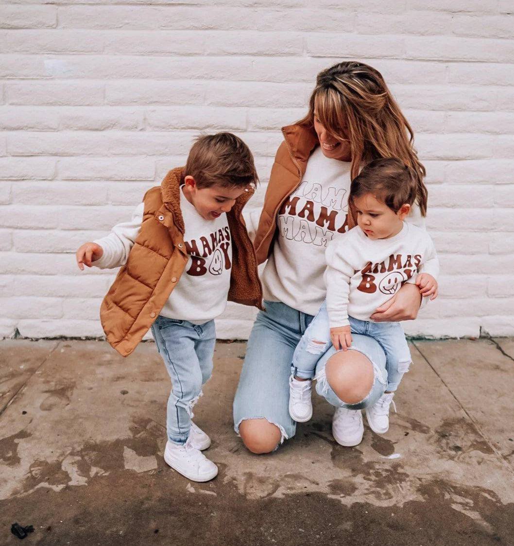 a mom and her two boys wearing matching clothes