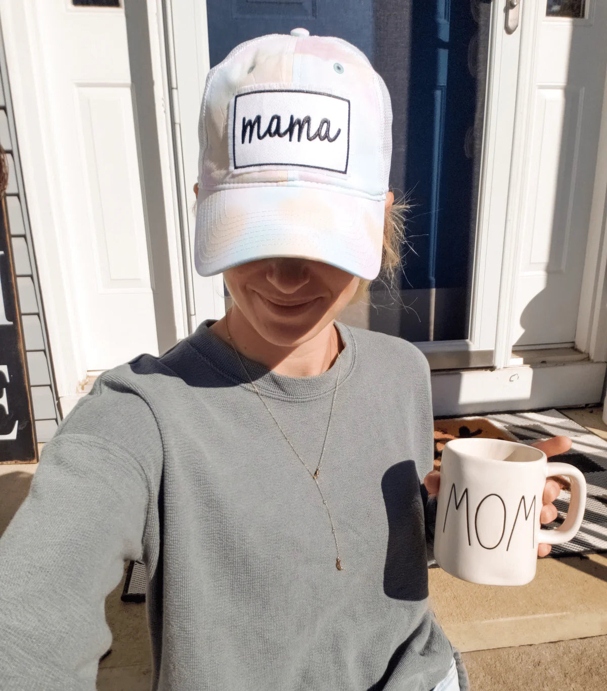 A mom wearing the Sorbert Tie Dye mama Trucker Hat