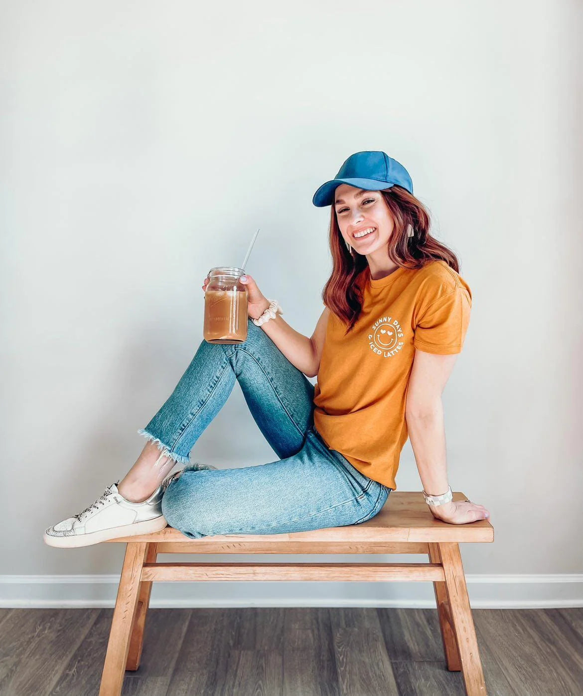 Model wearing an orange women’s summer graphic tee